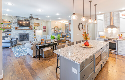 Custom interior based off of Vandalia modular home floor plan with a bright kitchen, hardwood floors, and grey finishes.